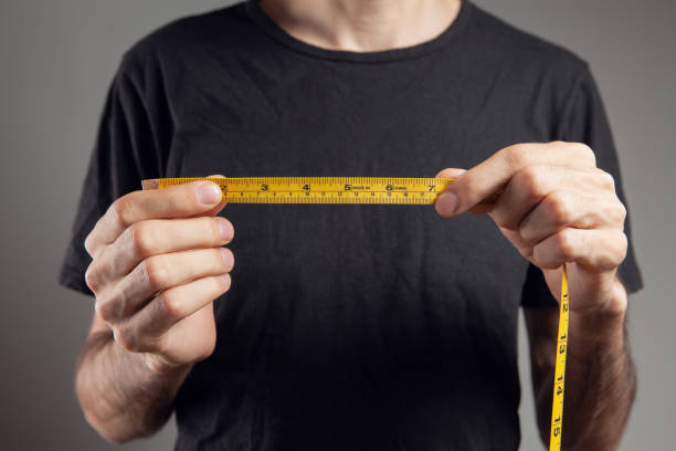 istock man holding a measuring tape 1361747288