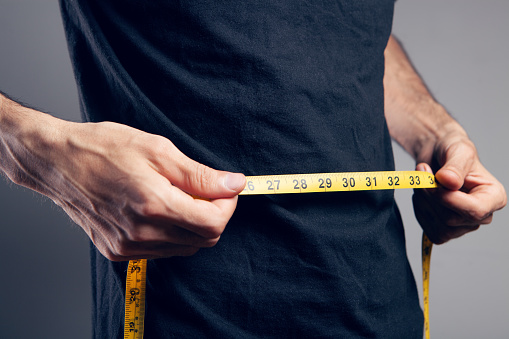a man holding a measuring tape in his hand