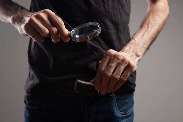 istock a man looks at the penis with a magnifying glass 1361747705