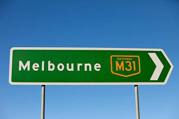 istock Road sign points to the right towards Melbourne 136175092