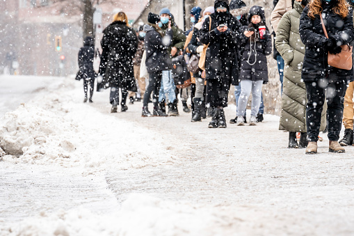 People waiting in line outside a screening clinic providing Covid-19 testing in Montreal, Quebec, during winter.