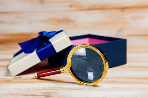 istock magnifying glass and a gift 1361755070