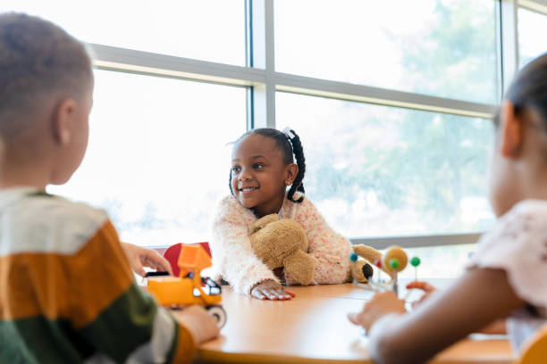 istock Happy preschool student enjoying class 1361756671