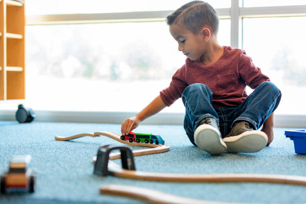 istock Independent boy plays with trains in daycare 1361756746