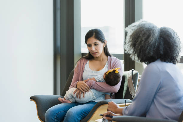 istock Woman with postpartum depression talks to unrecognizable therapist 1361756868