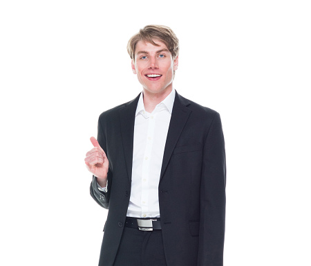 One person of aged 20-29 years old caucasian male business person in front of white background wearing shirt who is smiling who is show shaka sign ( hang loose )