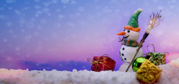 istock Gift packages and snowman on the snow. 1361762095