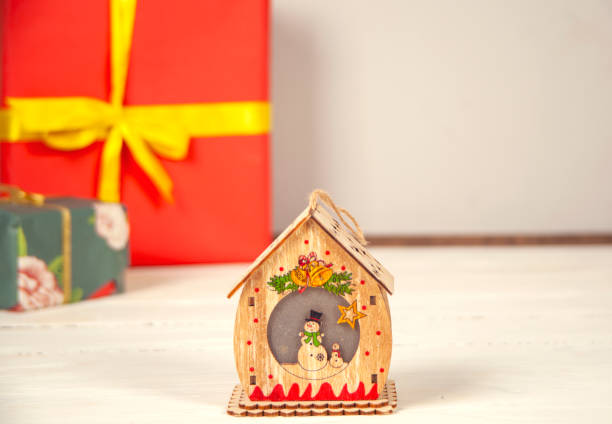 istock Gift box and house model on the wooden table. 1361762156