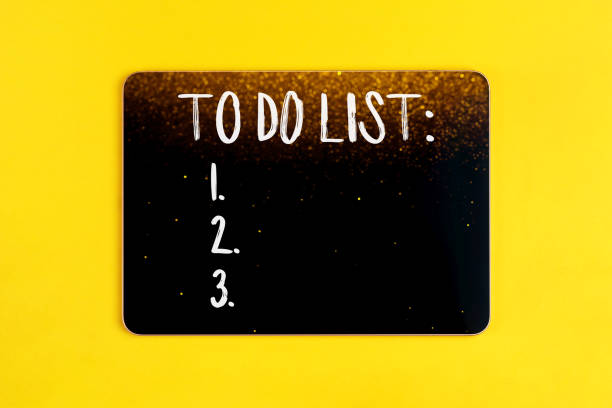 istock Digital tablet with to do list on yellow background with lights 1361763253