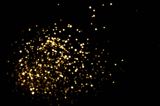 istock Golden blurred bokeh lights on black background 1361763329