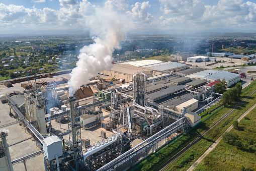 Aerial view of oil and gas refining petrochemical factory with high refinery plant manufacture structure. Global production and manufacturing concept.