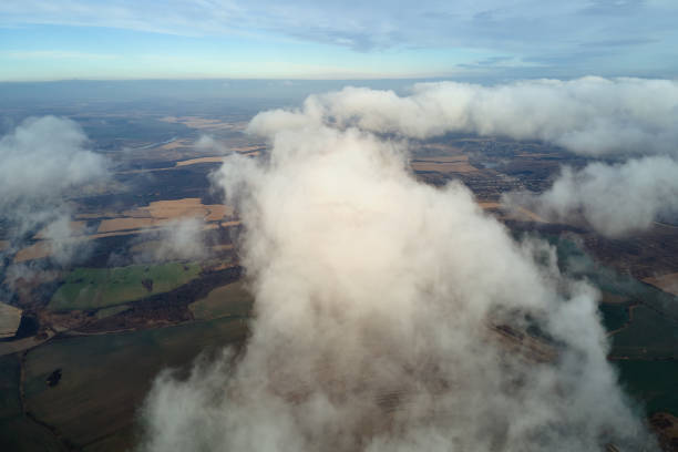 istock Aerial view from high altitude of earth covered with puffy rainy clouds forming before rainstorm 1361764457