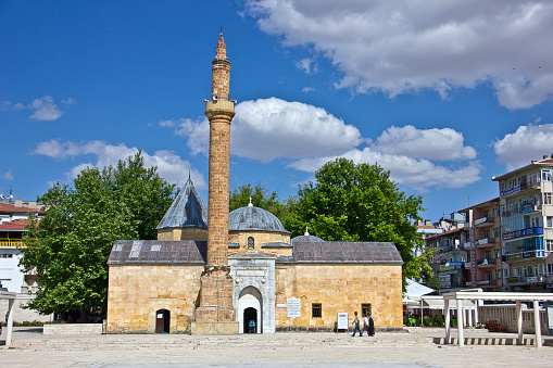 Kırşehir, Turkey - July 11, 2021: Kırsehir center view at summer time, people on the square to see the Mosque and Tomb, which was built in 1482 in the name of Ahi Evran, the founder of the Ahilik Organization, is located in the city center of Kırşehir.