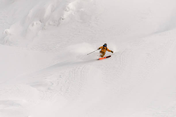 istock freeride skier rides on powder snow down the slope 1361773073