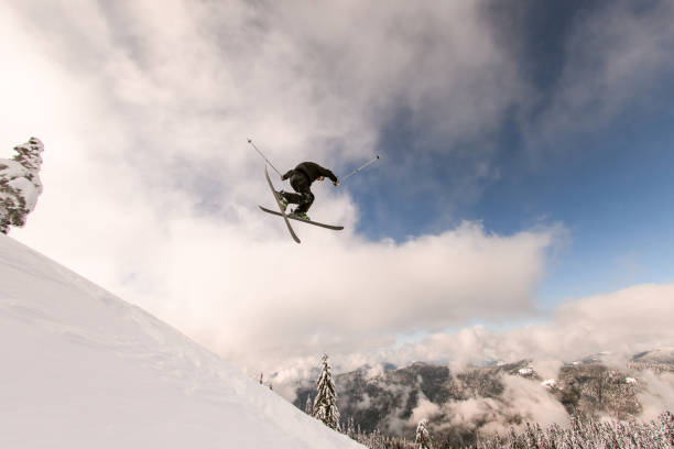 istock skier performs masterful jump in the air over snowy mountain slope 1361773356