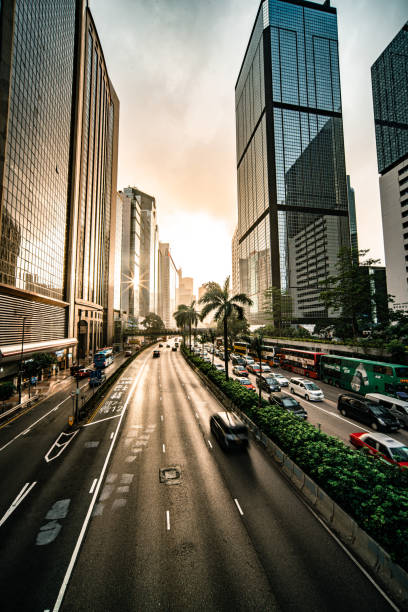 hong kong traffic zooming through skyscraper avenue - city vitality speed highway imagens e fotografias de stock