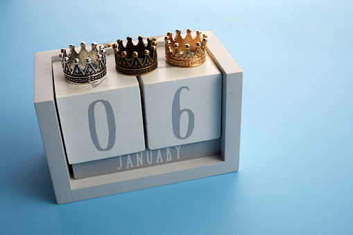 Epiphany Day Concept. 6 January calendar with three crowns on bue background.