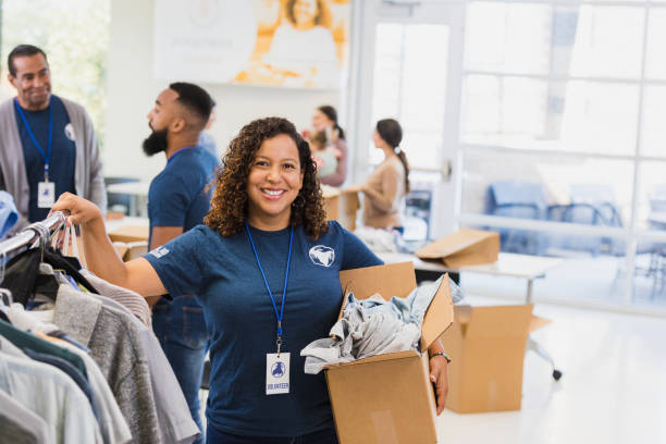 istock Clothing drive organizer smiles for camera 1361776922