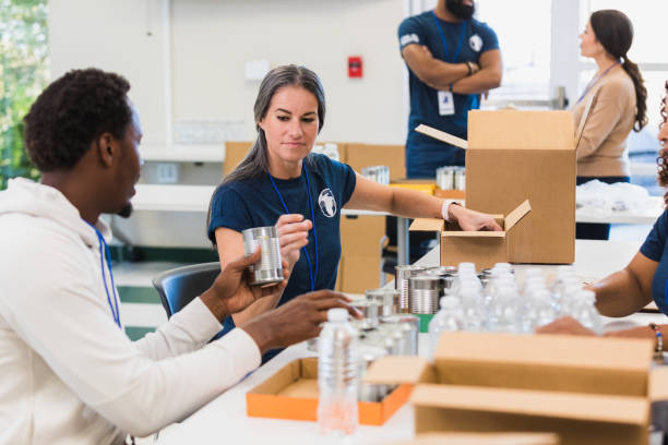 istock Group food drive volunteers pack donations 1361777324