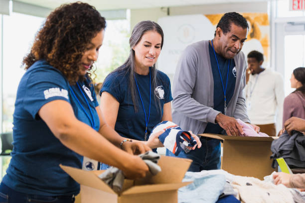 istock Volunteers sort out donations during clothing drive 1361777337