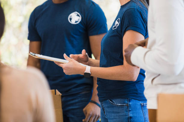 istock Close-up unrecognizable adults standing near volunteer coordinator 1361778512