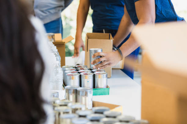 istock Close-up view unrecognizable people sorting donated food 1361778515
