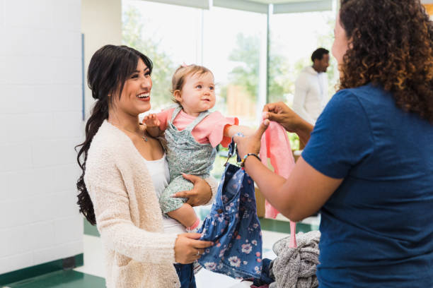 istock Single mom smiles when offered clothes for baby 1361778790