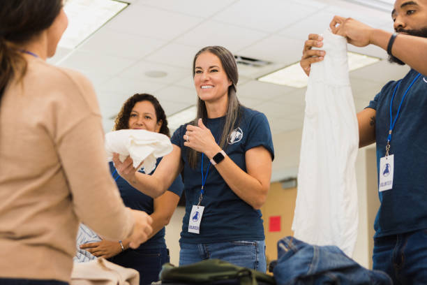istock Diverse volunteers sort and fold clothing in thrift shop 1361780121