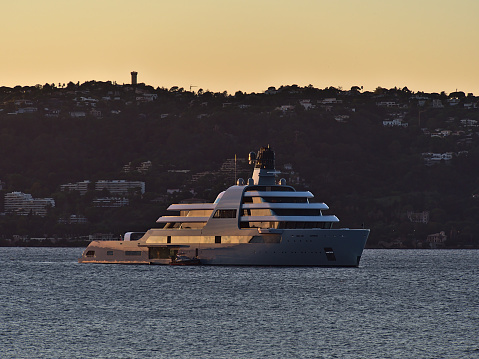 Antibes, Provence-Alpes-Cote d'Azur, France - 11-05-2021: View of huge superyacht Solaris, owned by Russian businessman Roman Abramovich, in the evening sun moored in the bay of Antibes, France.