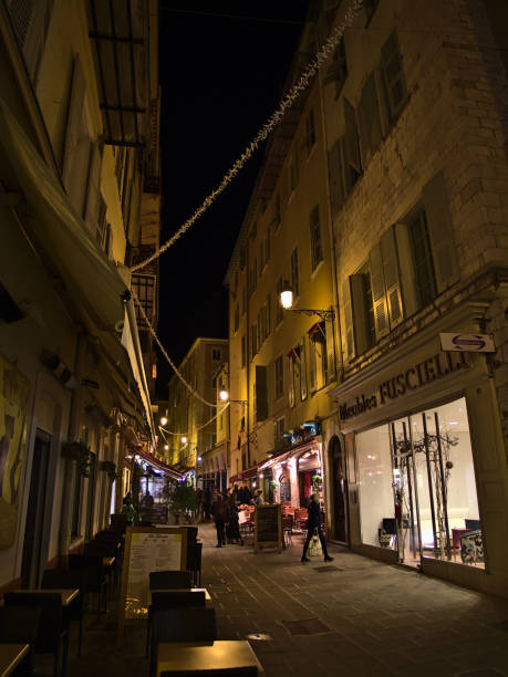 busy night scene in downtown of nice, france at the french riviera with people walking through illuminated narrow alley, restaurant and shops. - city of nice restaurant france french riviera imagens e fotografias de stock