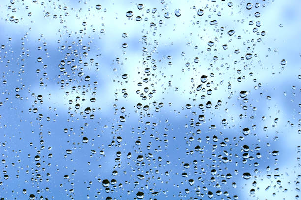 istock Window glass full of raindrops behind which is a cloudy sky 1361785963
