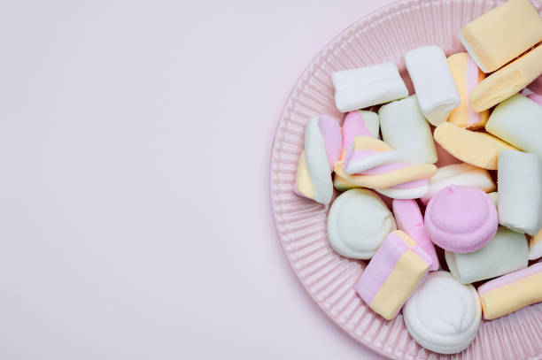 istock purple plate with marshmallows, copy space 1361789223