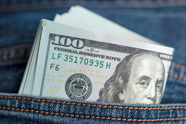 istock Dollar bills in jeans pocket 1361792079