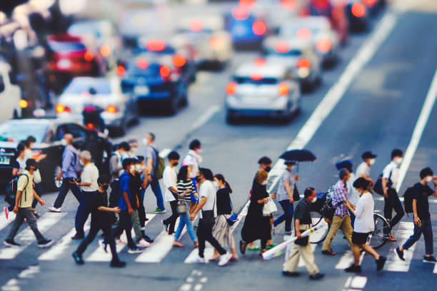 istock Many people walking in the downtown area 1361793396