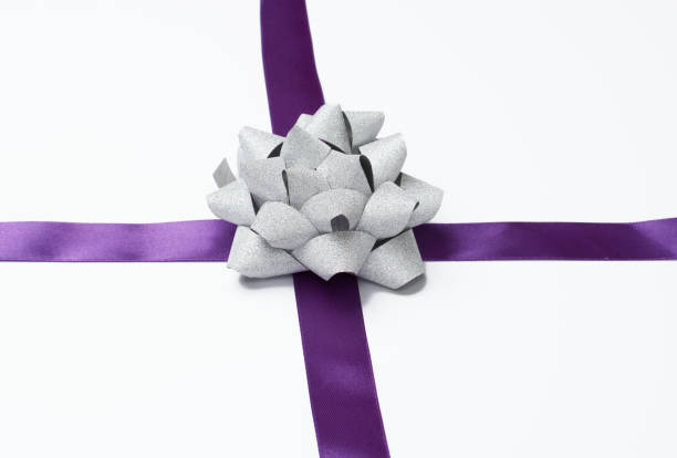 istock bow and purple silk ribbon on a white background, design element for gift decor 1361796370