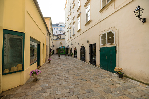 an narrow alley in the city on a bright day