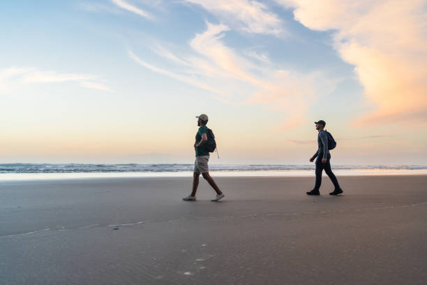 istock After a long hike reached at beach. 1361801429