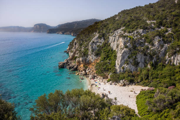 istock Small sandy beach along the coast with a few people, Sardinia, Italy. 1361801598