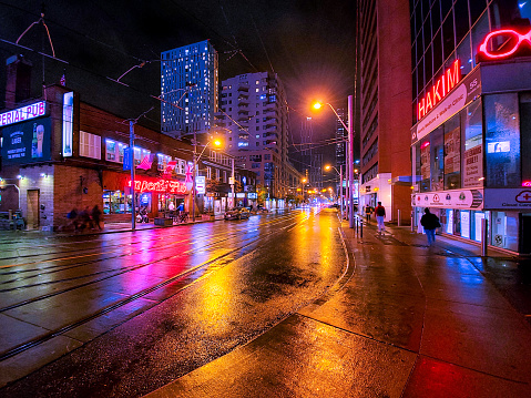 Walking on Yonge Street at night. Yonge Street is a major arterial route in the Canadian province of Ontario connecting the shores of Lake Ontario in Toronto to Lake Simcoe, a gateway to the Upper Great Lakes.