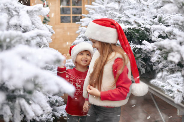istock Children choose a Christmas tree in a shop 1361806460