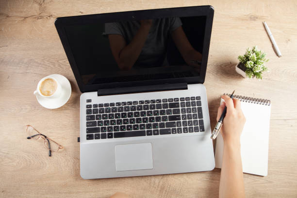 istock young girl taking notes in a notebook in front of a work table 1361807719