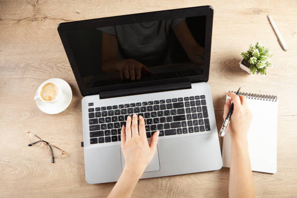 istock young girl taking notes in a notebook in front of a work table 1361807721