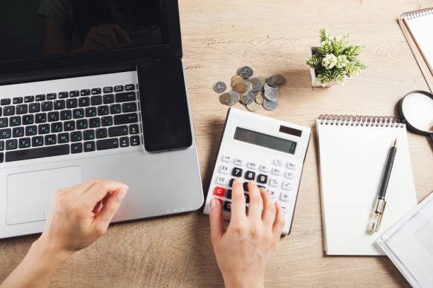 istock counts money on a calculator at the desktop 1361807733