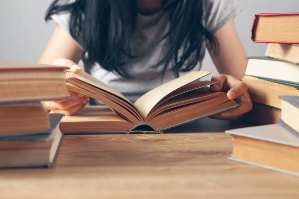 istock girl reading a book in the library 1361808319