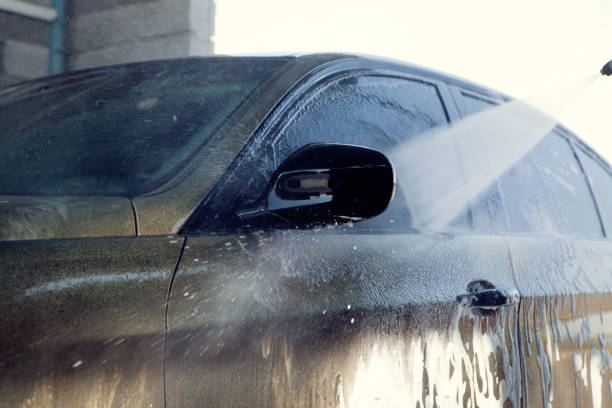 istock a man washes his car with water 1361808400