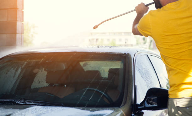 istock a man washes his car with water 1361808401