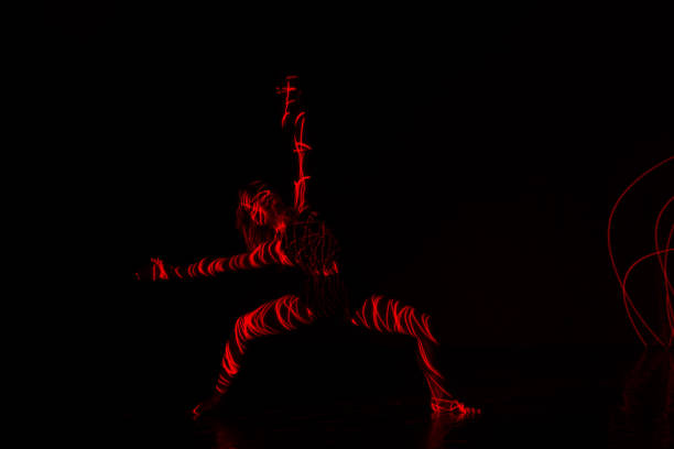 istock Ballet dancer dancing in front of and red light while expressing the hell with her magnificent dance moves. 1361809873
