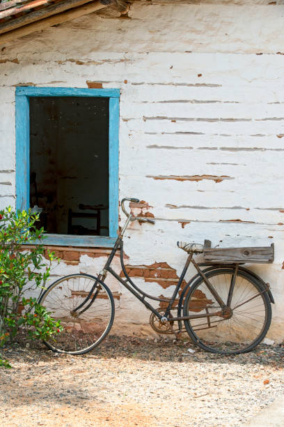 istock Old bicycle leaning against the wall 1361810791