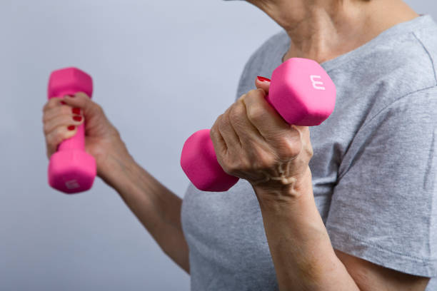 istock Senior woman with dumbbells 1361817310
