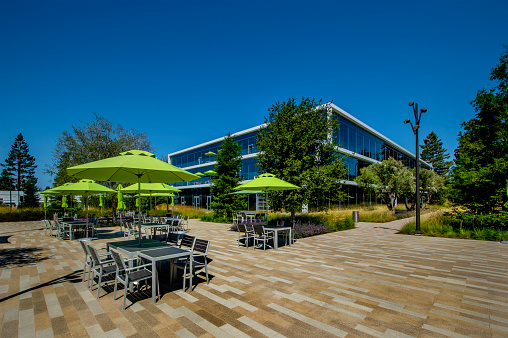 Office park with tables and umbrellas.